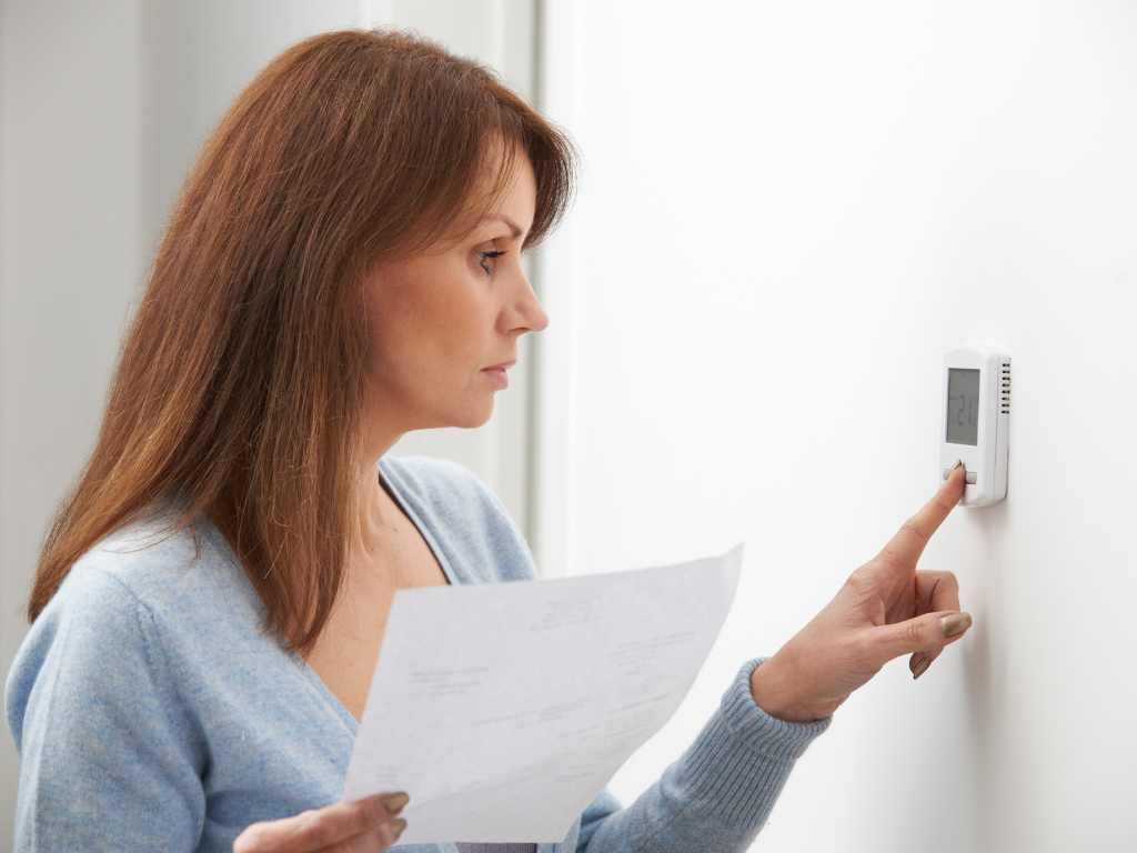 Woman adjusting room temperate